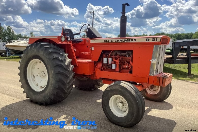 A red tractor ready for auction, sitting in a lot
